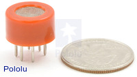Gas sensor with orange plastic case with quarter for size reference.