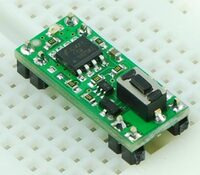 Pololu Pushbutton Power Switch on a solderless breadboard.