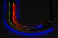 A 3pi robot following a line in the dark, making the glow of the LEDs more apparent.
